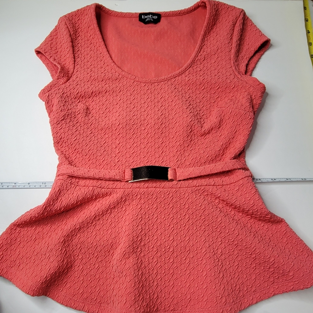 Bebe size M salmon / coral  color top with back cut out and front gold accent.